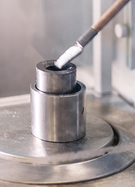 Hands weighing a substance on a scale in a laboratory setting
